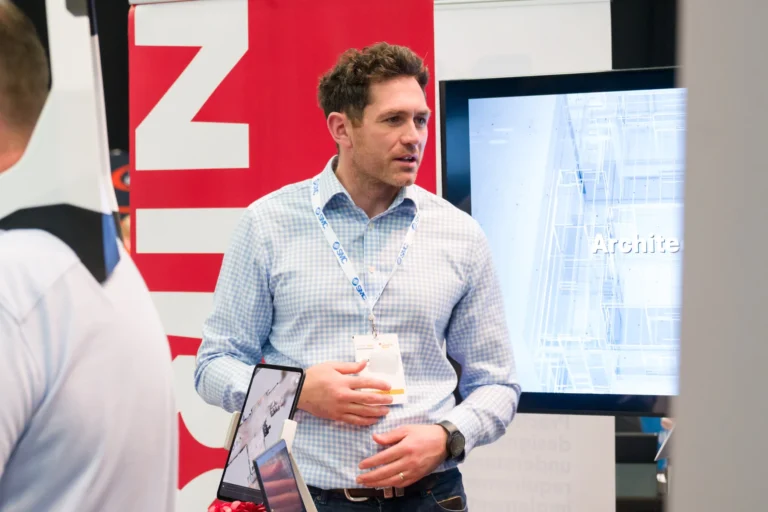 Delegate talking beside an exhibition display at the 2026 Sustainable Food Factory and Food+Beverage Engineering event.