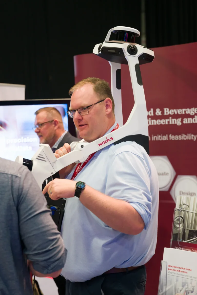 Delegate wearing a headset on the exhibition floor at the 2026 Sustainable Food Factory and Food+Beverage Engineering event.