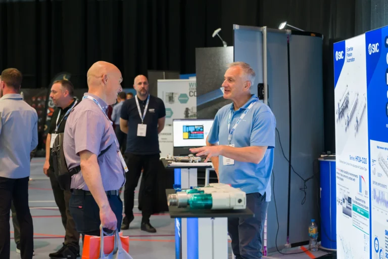 Exhibitor explaining equipment to a visitor at the 2026 Sustainable Food Factory and Food+Beverage Engineering event.