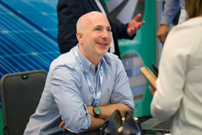 Exhibitor welcoming a visitor at a table at the 2026 Sustainable Food Factory and Food+Beverage Engineering event.