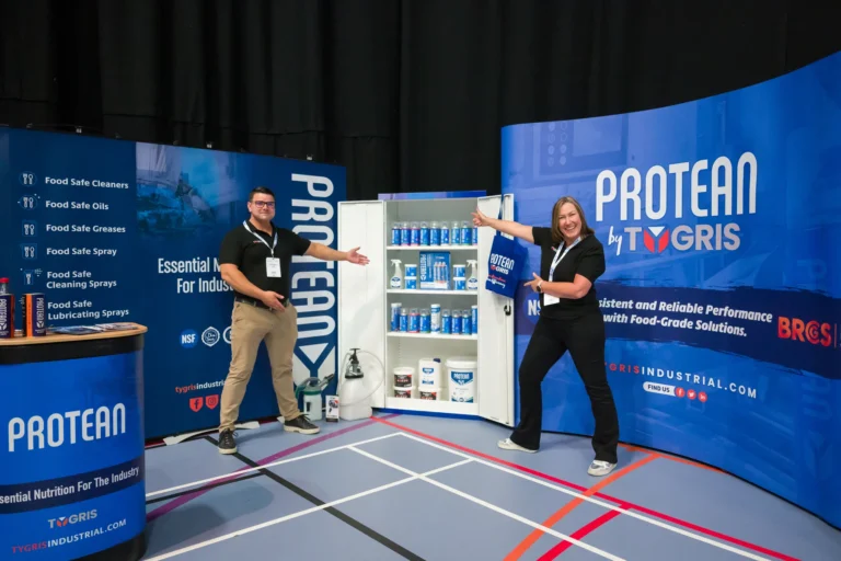 Exhibitors posing beside their technology display at the 2026 Sustainable Food Factory and Food+Beverage Engineering event.