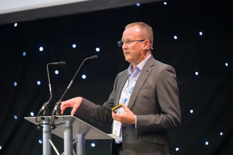 Speaker delivering a presentation at the lectern at the 2026 Sustainable Food Factory and Food+Beverage Engineering event.