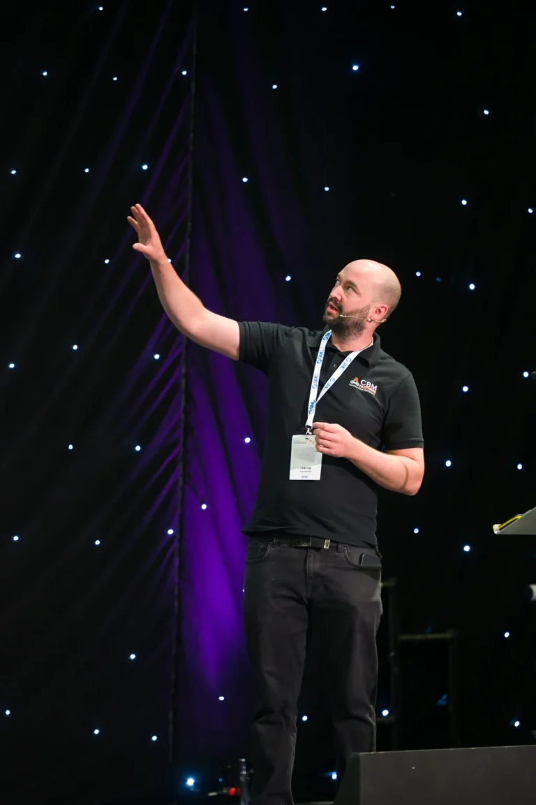 Speaker raising a hand on the seminar stage at the 2026 Sustainable Food Factory and Food+Beverage Engineering event.